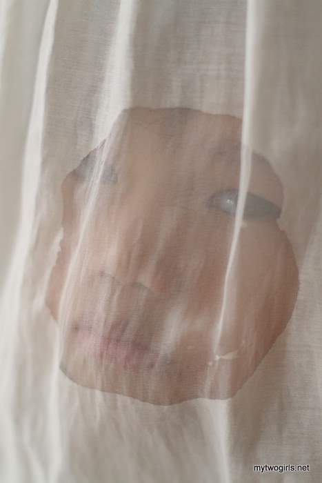 Zaria hiding behind the curtains